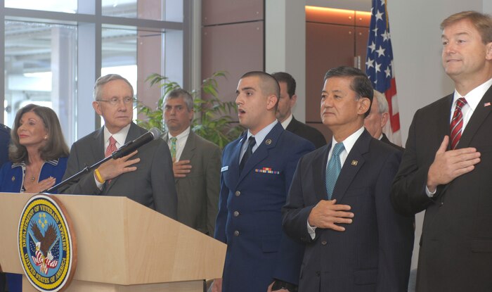 U.S. Air Force Airman 1st Class Cory Bassett, 57th Operations Support Squadron, sings the National Anthem during the dedication of the North Las Vegas Veterans Affairs Medical Center Aug. 6, 2012, in North Las Vegas, Nev. Also present are (from left) Rep. Shelley Berkley, D-Nev., Sen. Harry Reid, D-Nev., Secretary of Veterans Affairs Eric K. Shinseki and Dean Heller, R-Nev. Maj. Gen. Jeffrey Lofgren, U.S. Air Force Warfare Center commander, also attended as the senior Nellis Air Force Base representative.  The North Las Vegas VA Medical Center will be the first built in the United States in 17 years, the first-ever built in southern Nevada and is anticipated to serve about 60,000 veterans out of some 400,000 who live in Nevada. (U.S. Air Force photo by Master Sgt. David Miller)

