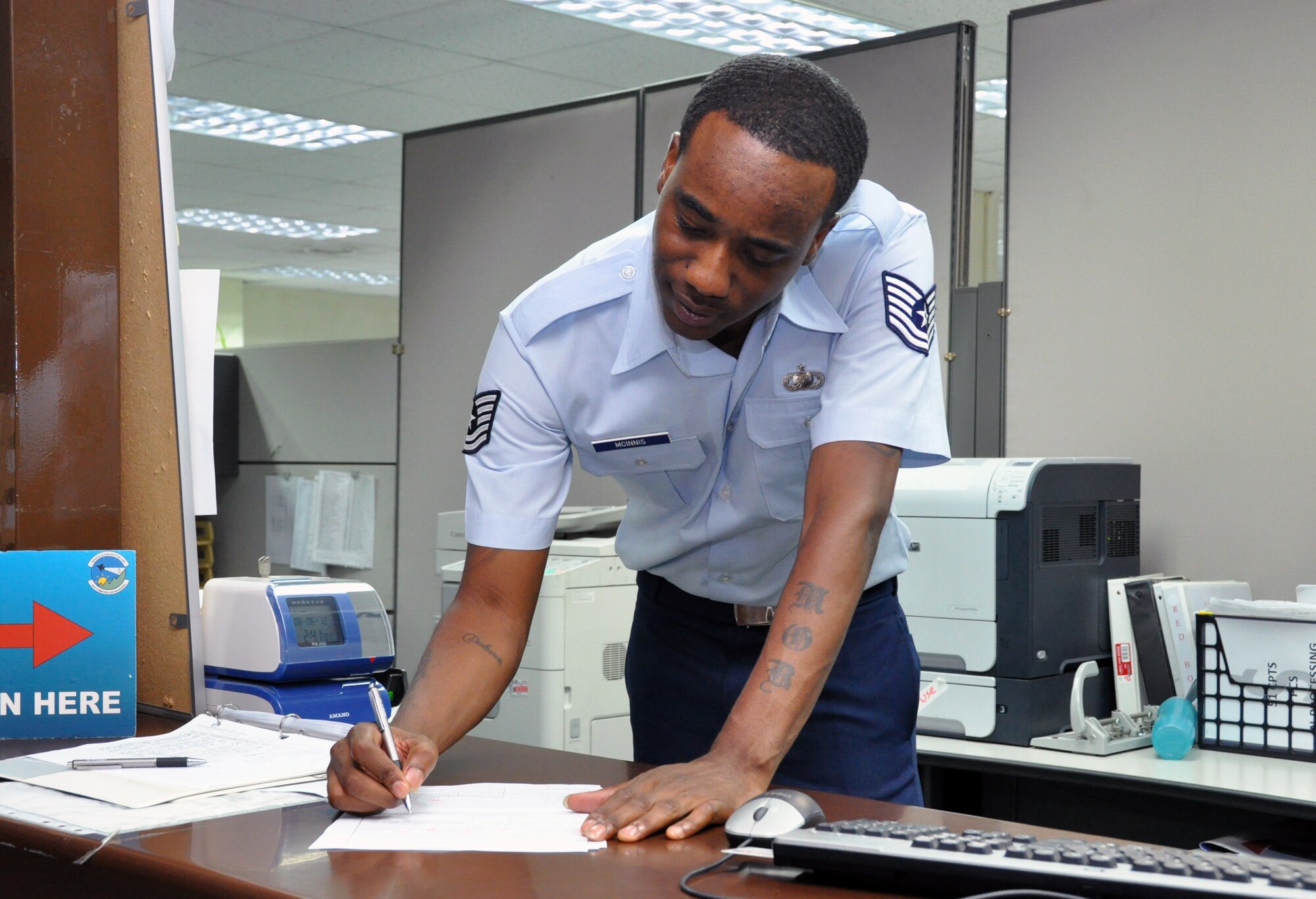 Tech. Sgt. Rodney Mcinnis, 51st Comptroller Squadron customer service chief, reviews a service member’s travel voucher at Osan Air Base, Republic of Korea, Aug. 7, 2012. On average, the finance customer service section works roughly 12 hour days to process nearly 500 travel vouchers within the first 10 days of each month. The finance office currently operates with a staff of 18 personnel to process nearly $1.5 million in travel vouchers. (U.S. Air Force photo/Senior Airman Michael Battles)