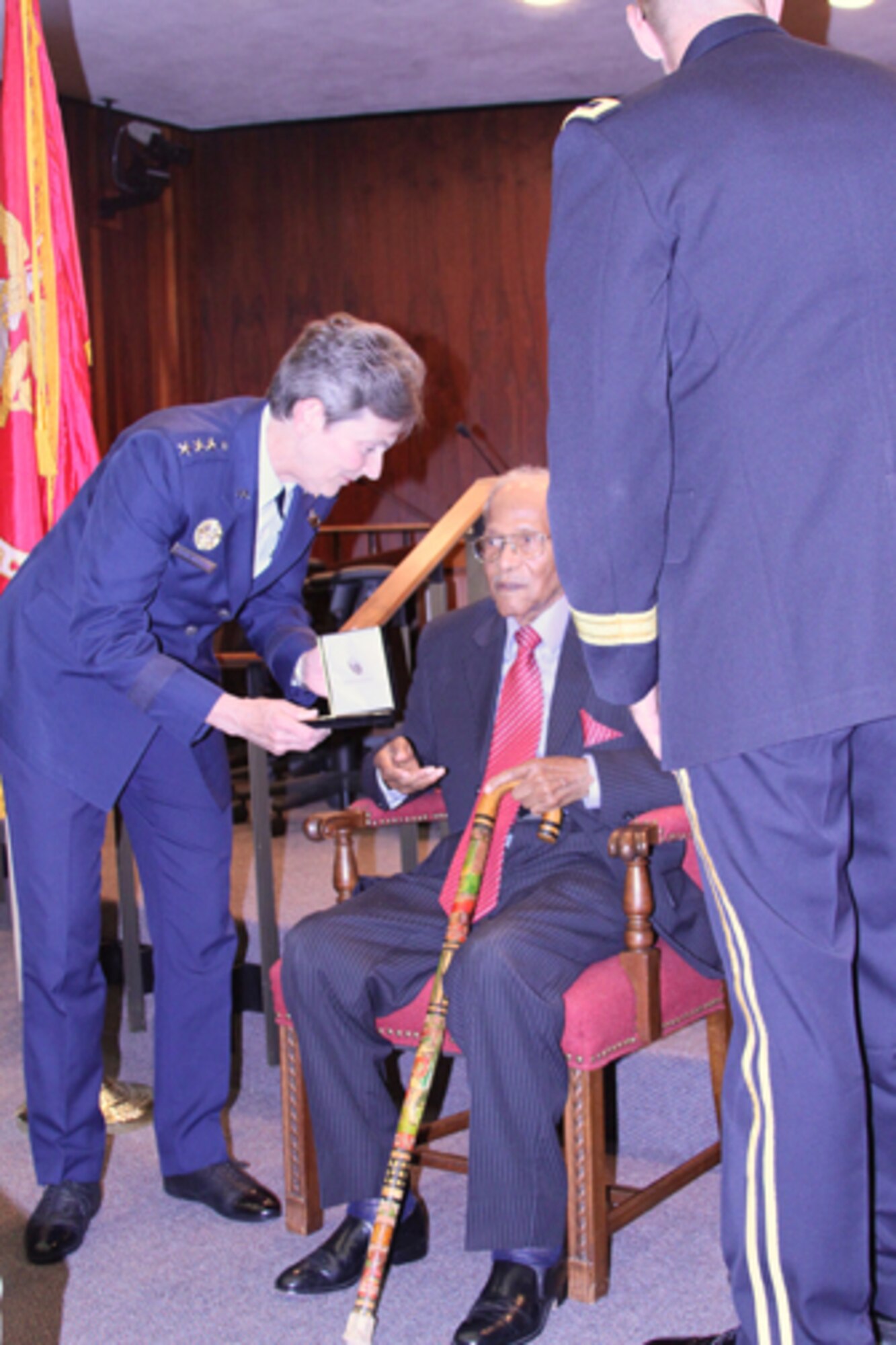 Lieutenant Gen. Ellen Pawlikowski, SMC commander, presents a replica of the Congressional Gold Medal to Torrance resident and Tuskegee Airman Walter Crenshaw at the Torrance City Council meeting, July 24. The medal was awarded to the Tuskegee Airmen in 2007 during a ceremony in Washington D.C.; however, Crenshaw, who is 102 years old, was unable to attend. (Photo courtesy of Torrance City Cable)