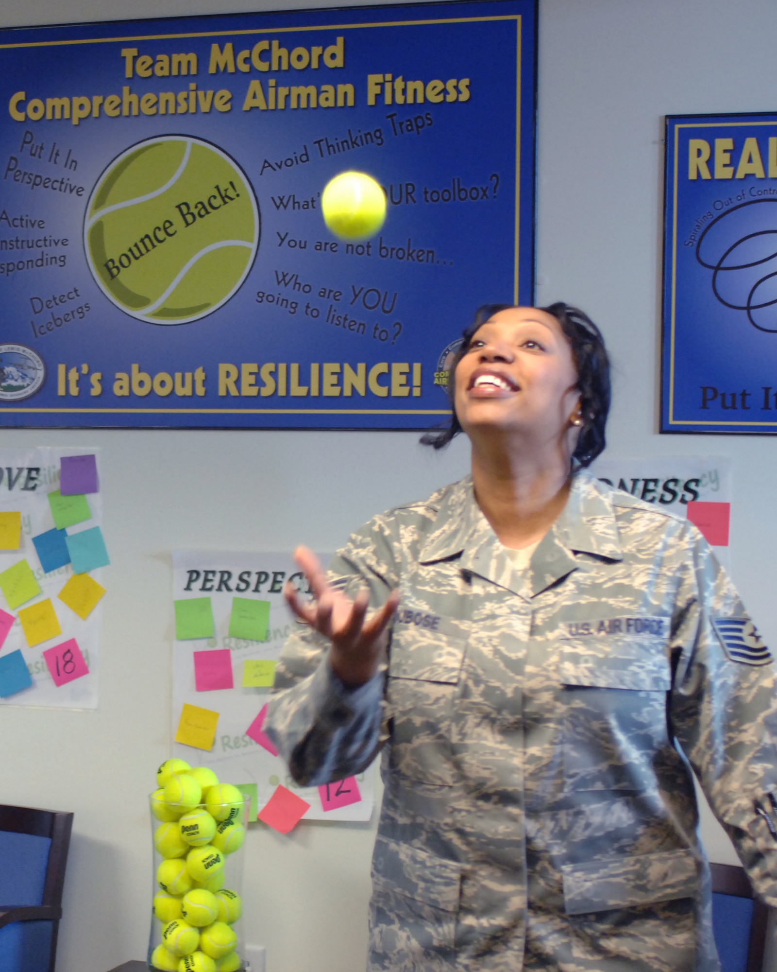 Tech. Sgt. Monique Dubose, McChord Field lead master resilience trainer, tosses a tennis ball in the air at the Airman Resilience Center Aug. 8, 2012, at Joint Base Lewis-McChord, Wash. Dubose uses tennis balls in the class to symbolize the resilience required to "bounce back" in the face of adversity. (U.S. Air Force photo/Staff. Sgt. Sean J. Tobin)