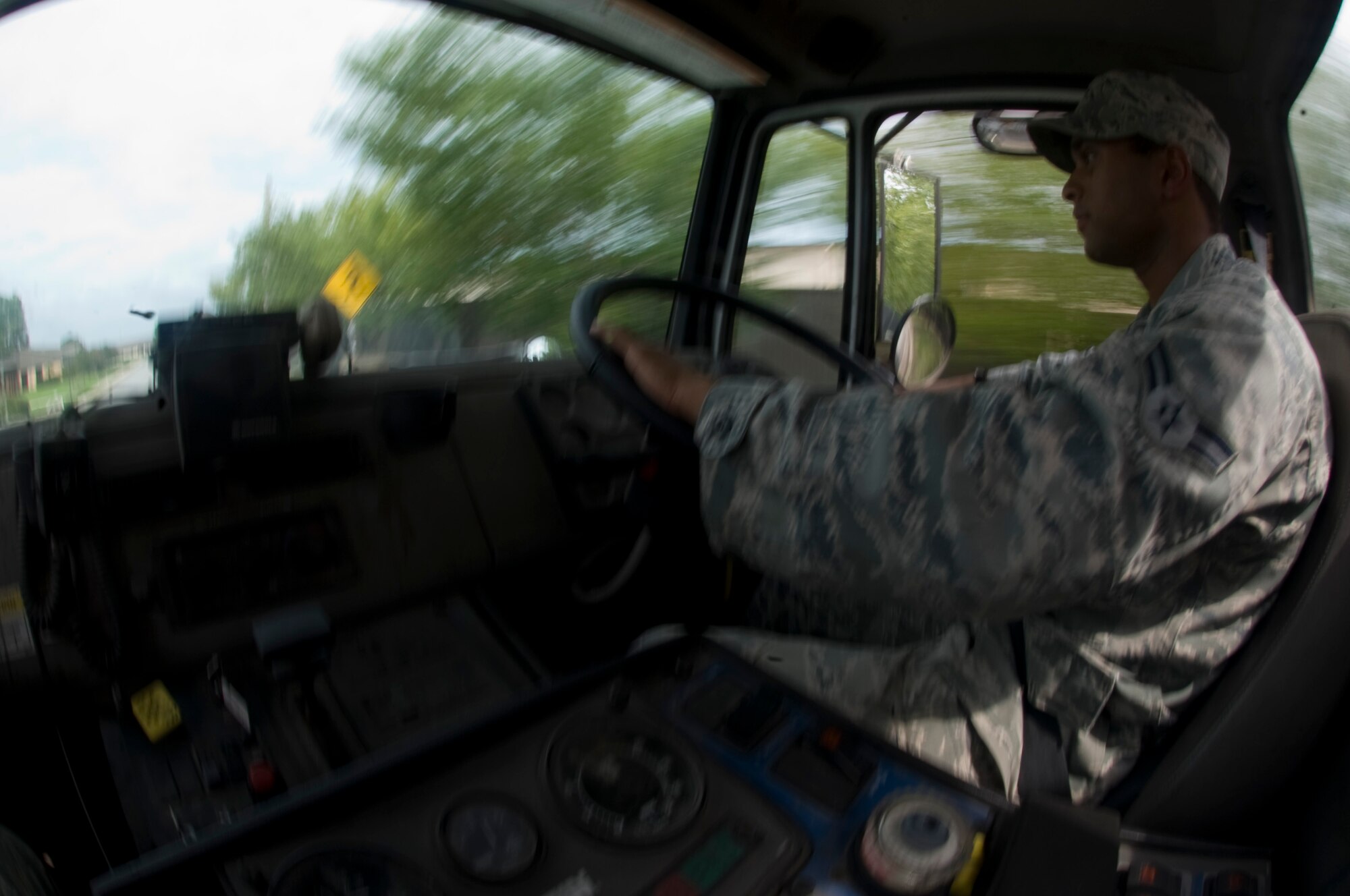 U.S. Air Force Airman 1st Class Salman Syed, a reservist pavement and construction heavy equipment operator from the 1st Special Operations Civil Engineering Squadron, drives a street sweeper on Independence Road, Hurlburt Field, Fla., Aug. 8, 2012. Street sweeping is an effective method of removing large debris that can block storm water facilities, causing localized flooding during heavy rains. (U.S. Air Force Photo/Airman 1st Class Hayden K. Hyatt)