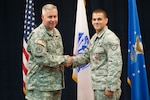 U.S. Army Col. Robert Bridgford, 502nd Air Base Wing vice commander, congratulates Staff Sgt. Christopher Keilman, 902nd Security Forces Squadron military working dog handler, after presenting him with the Bronze Star Medal July 31 at the Joint Base San Antonio-Randolph Kendrick Club. (U.S. Air Force photo by Benjamin Faske)
