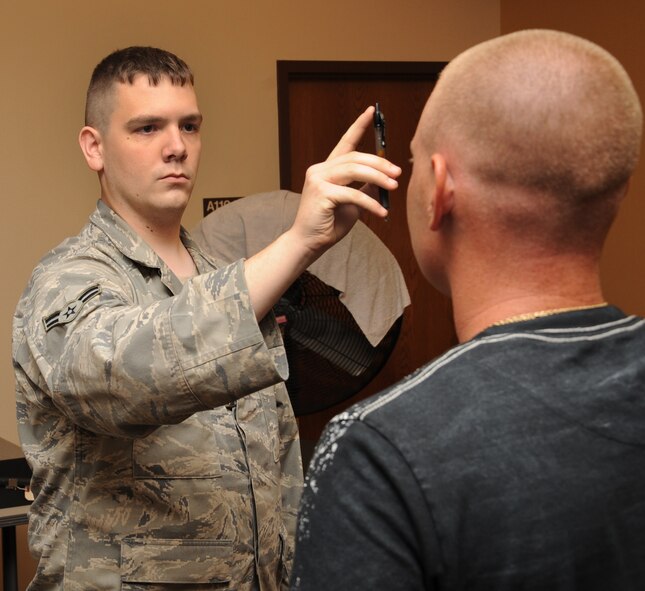Airman 1st Class Jason Lincoln, 2nd Security Forces Squadron installation control leader, administers the Horizontal Gaze Nystagmus, or pen test, to a training participant during standard field sobriety training on Barksdale Air Force Base, La., Aug. 7. More than 25 personnel from 2 SFS attended this training in order to become qualified to conduct field sobriety tests in the field. (U.S. Air Force photo/ Senior Airman Sean Martin)(RELEASED)