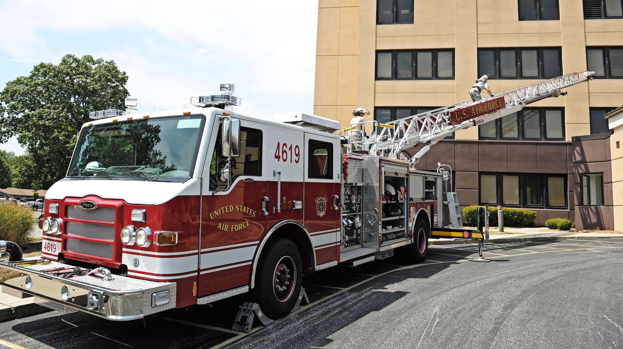 Firefighters from the 375th Civil Engineer Squadron recieve training on how to operate the firetruck's ladder apparatus Aug. 8, 2012 at Scott Air Force Base, Ill. The fire department is spending this week training on various pieces of equipment and scenarios to help them better serve the base and local community. (U.S. Air Force photo/ Staff Sgt. Ryan Crane)