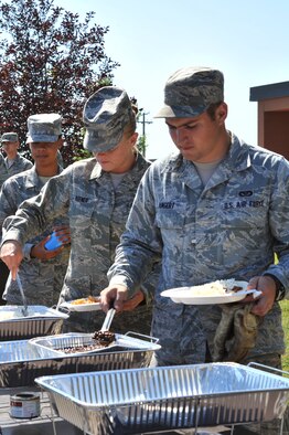 MINOT AIR FORCE BASE, N.D. -- Airmen grab food at the "Mexican Feast" during Wingman day here, Aug. 6. Wingman Day was designed to promote a sense of camaraderie within the squadron and to allow members to get to know one another in a relaxed atmosphere. (U.S. Air Force photo/Senior Airman Brittany Y. Auld)