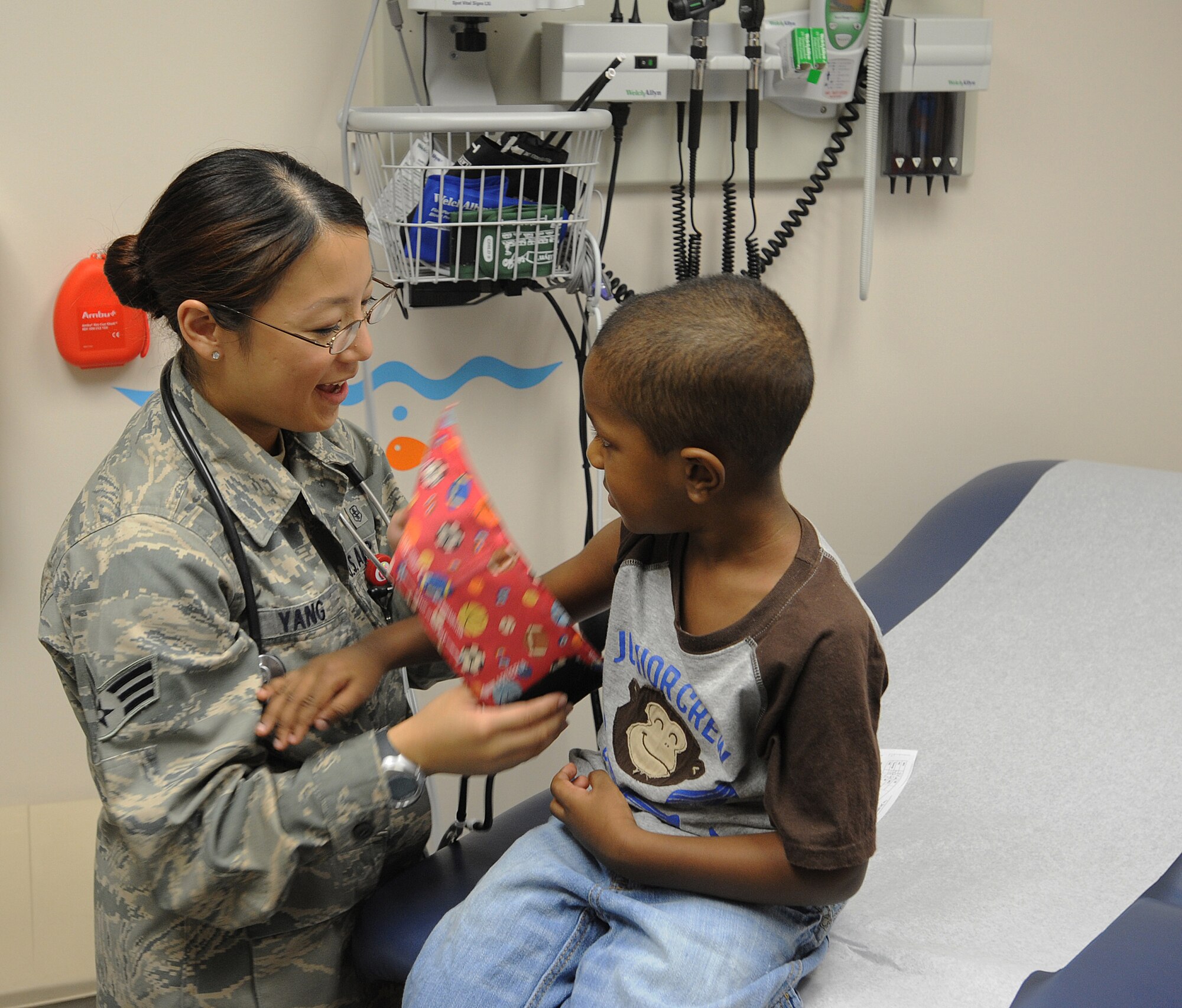 Senior Airman LuAnn Yang, 22nd Medical Operations Squadron aerospace medical technician, prepares SoMaj, 3, to have his blood pressure taken during a routine check-up, Aug. 8, 2012, McConnell Air Force Base, Kan. As an aerospace medical technician, Yang checks-in patients by measuring their vital signs, including heart rate and blood pressure, while going over patient medical history for any problems and preparing their concerns for the physician. Yang was recognized as the spotlight performer for the week Aug. 6 to 10, 2012. (U.S. Air Force photo/Airman 1st Class Victor J. Caputo)