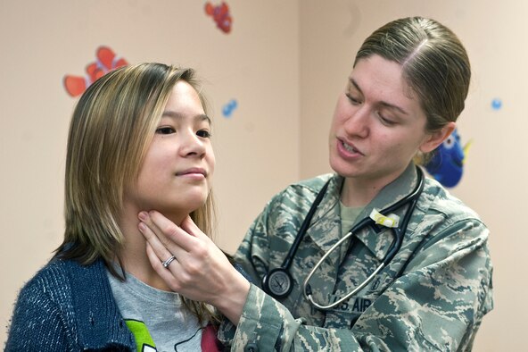 U.S. Air Force Capt. Sandra Swedean, 99th Medical Operations Squadron pediatrician, examines Marcelle Mancravie, 13, daughter of U.S. Navy Senior Chief Petty Officer retired Marc Mancravie, during a pediatrics sports physical at the Mike O'Callaghan Federal Medical Center Aug. 8, 2012, at Nellis Air Force Base, Nev. The 99th Medical Group is conducting school physicals for school age children that are returning for the school year.   (U.S. Air Force photo by Staff Sgt. Christopher Hubenthal)