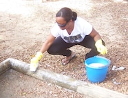 Staff Sgt. Felicia Hollins, 916th Crew Communications, paints playground equipment as part of a community service project while deployed overseas. (USAF photo by SSgt. Kenya McCall, 916th SARM)