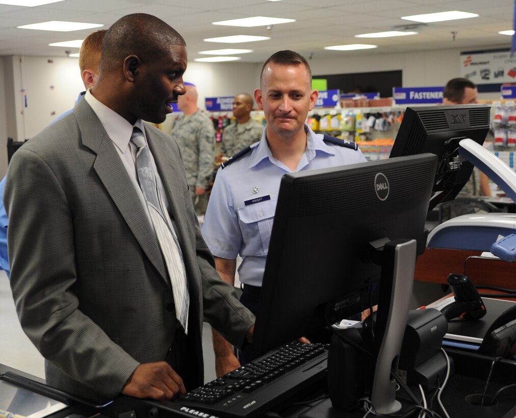 Keith Tyson, AbilityOne Base Supply Center associate, demonstrates his responsibilities to Col. William Knight, 11th Wing/ Joint Base Andrews commander, after the center’s grand opening ceremony on Aug. 7, 2012. The Base Supply Center is operated by the Blind Industries and Services of Maryland. The grand opening featured dignitaries, guest speakers and musical performances.  (U.S. Air Force photo/ Staff Sgt. Keyonna Fennell)
