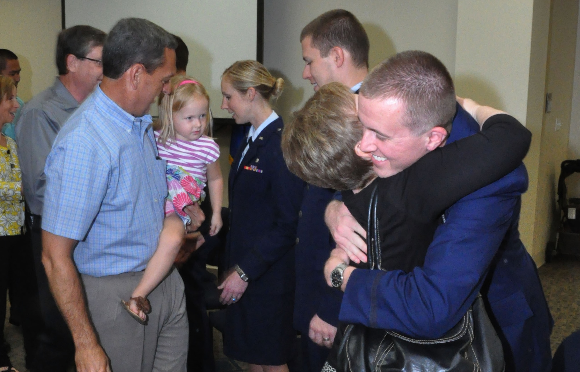Friends and family of the graduates congratulate them on completing the AEGD program July 31, 2012 at the Scott Medical Clinic. The residents advanced in their training by learning complex root canals, complex impacted third molars, wisdom teeth extractions along with other techniques and surgeries. (U.S Air Force photo/Airman 1st Class Jake Eckhardt)