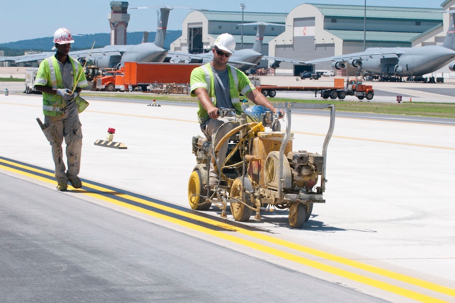 Contractors spray paint lines onto the edge of the newly aligned taxiway at the 167th Airlift Wing, Shepherd Field, Martinsburg WV, July 25, 2012.  Final touches are being made to the taxiway, which was recently realigned and extended; the final C-5 conversion construction project at the base. (Air National Guard photo by Master Sgt. Emily Beightol-Deyerle)