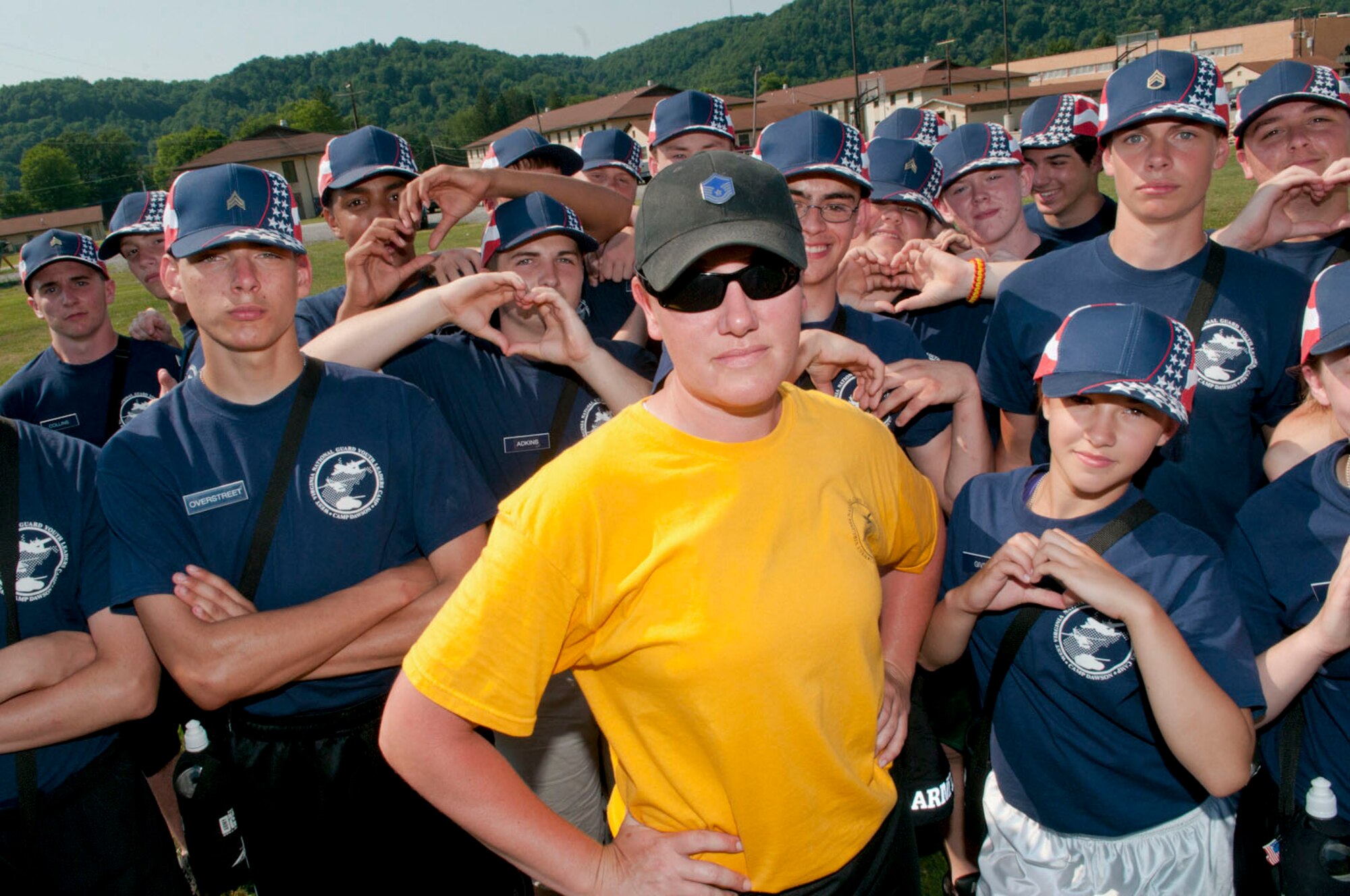 Master Sgt. Kelley McKinney, a trainer-advisor-counselor, or TAC, for the West Virginia
National Guard's Youth Leaders Camp, is surrounded by her platoon at Camp Dawson,
June 28, 2012. McKinney has been a TAC for the camp for six years. (Air National Guard photo by Master Sgt. Emily Beightol-Deyerle)
