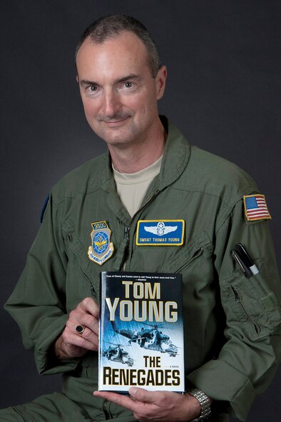 Senior Master Sgt. Tom Young displays a copy of his newest novel "the Renegades" which was released in early July. The book is the third in a series of military novels. Young is a C-5 flight engineer for the 167th Airlift Wing. (Air National Guard photo by Airman 1st Class Nathanial Taylor)
