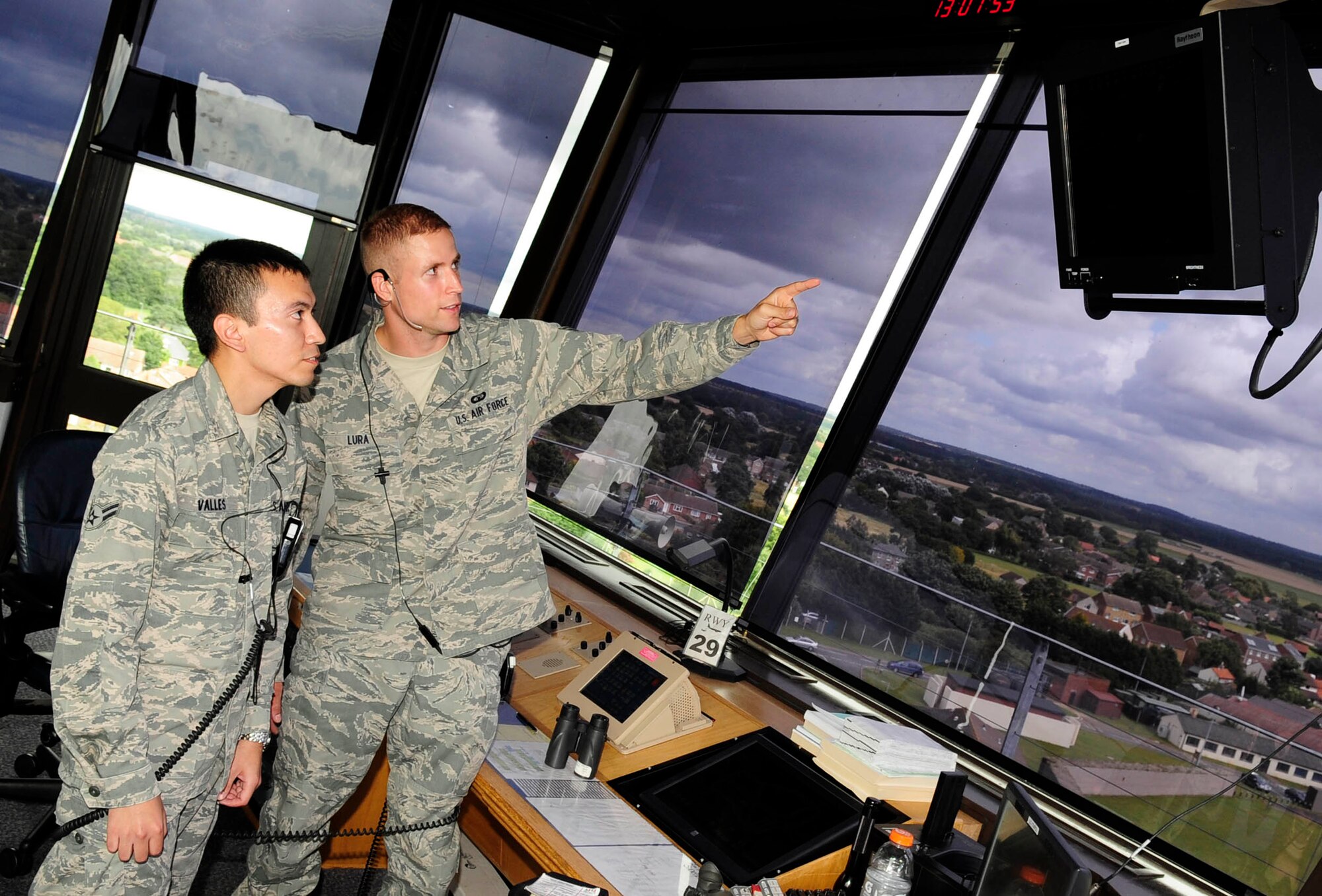 RAF MILDENHALL, England – Senior Airman Patrick Lura, right, 100th Operations Support Squadron air traffic controller, explains the dimensions of RAF Mildenhall’s air space while training Airman 1st Class Marc Valles, 100th OSS air traffic controller, in the air traffic control tower here Aug. 7, 2012.  The air traffic control tower here controls all planes within a 15-mile radius of RAF Mildenhall. (U.S. Air Force photo/Senior Airman Ethan Morgan)