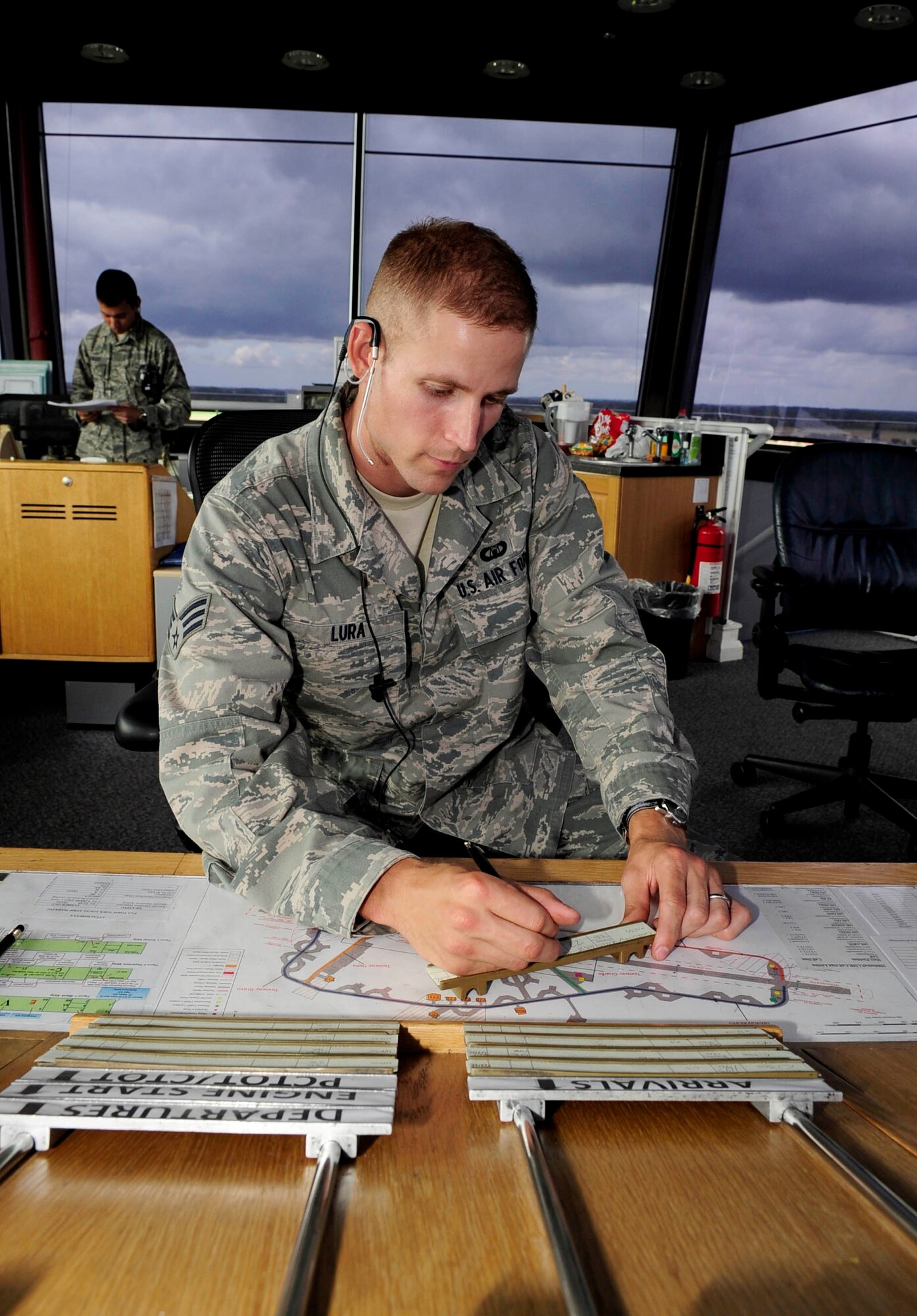 RAF MILDENHALL, England – Senior Airman Patrick Lura, 100th Operations Support Squadron air traffic controller, marks a flight progress strip in the air traffic control tower at RAF Mildenhall Aug. 7, 2012. The flight strips are used to monitor each aircraft's flight progress and information. (U.S. Air Force photo/Senior Airman Ethan Morgan)