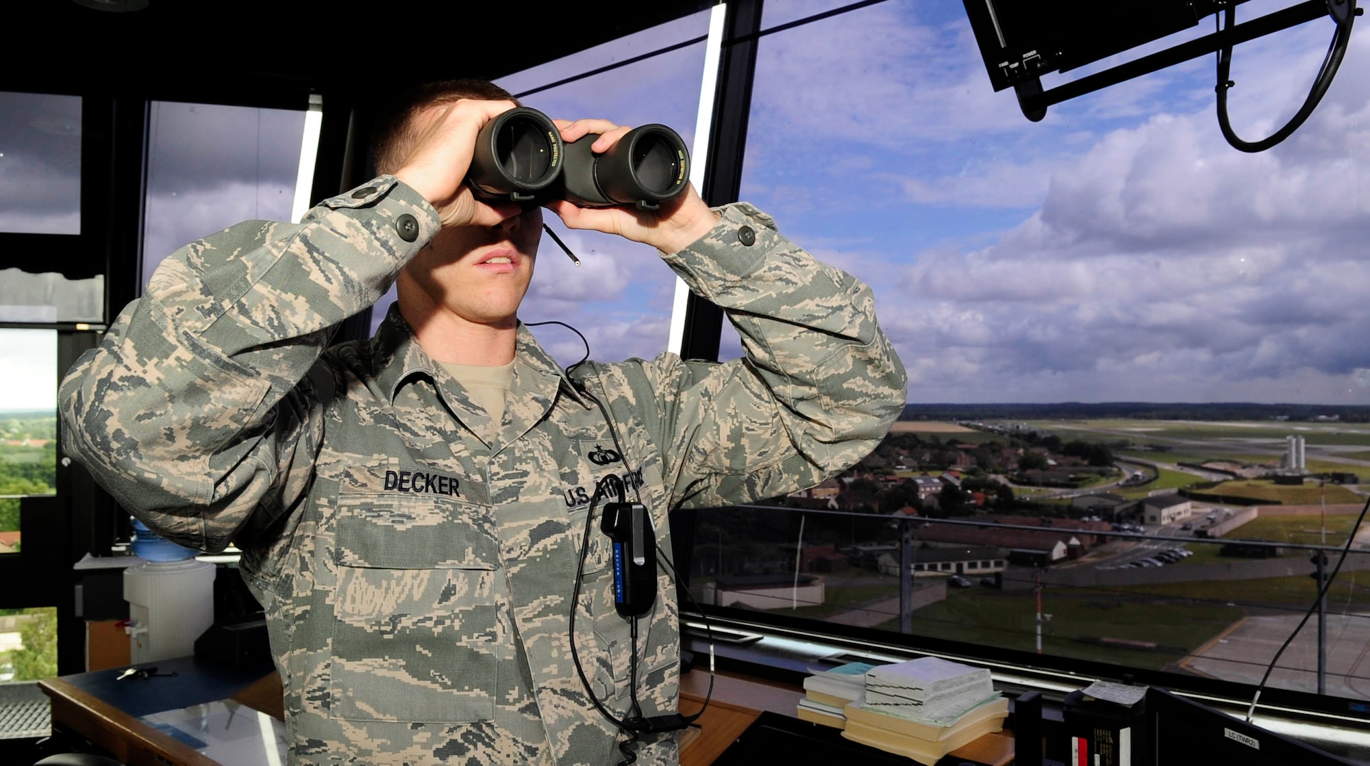 RAF MILDENHALL, England – Staff Sgt. Casey Decker, 100th Operations Support Squadron air traffic controller, makes visual confirmation of an incoming aircraft at RAF Mildenhall Aug. 7, 2012. Binoculars are used to maintain surveillance of the airfield and ensure that the landing gear is down on approaching aircraft. (U.S. Air Force photo/Senior Airman Ethan Morgan)
