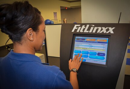 Staff Sgt. Kandra Truesdale, 628th Force Support Squadron Fitness Assessment Cell program manager, demonstrates how to use the FitLinxx program Aug. 6, 2012, at Joint Base Charleston – Air Base, S.C. FitLinxx connects with equipment used at the Fitness and Sports Center to track user’s work-outs. (U.S. Air Force photo by Senior Airman Anthony Hyatt)