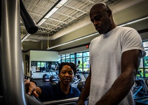 Staff Sgt. Kandra Truesdale, 628th Force Support Squadron Fitness Assessment Cell program manager, assists a customer on a treadmill Aug. 6, 2012, at Joint Base Charleston – Air Base Fitness and Sports Center, S.C. All Fitness and Sports Center staff members are experienced and trained on the equipment used at the facility.  (U.S. Air Force photo by Senior Airman Anthony Hyatt)