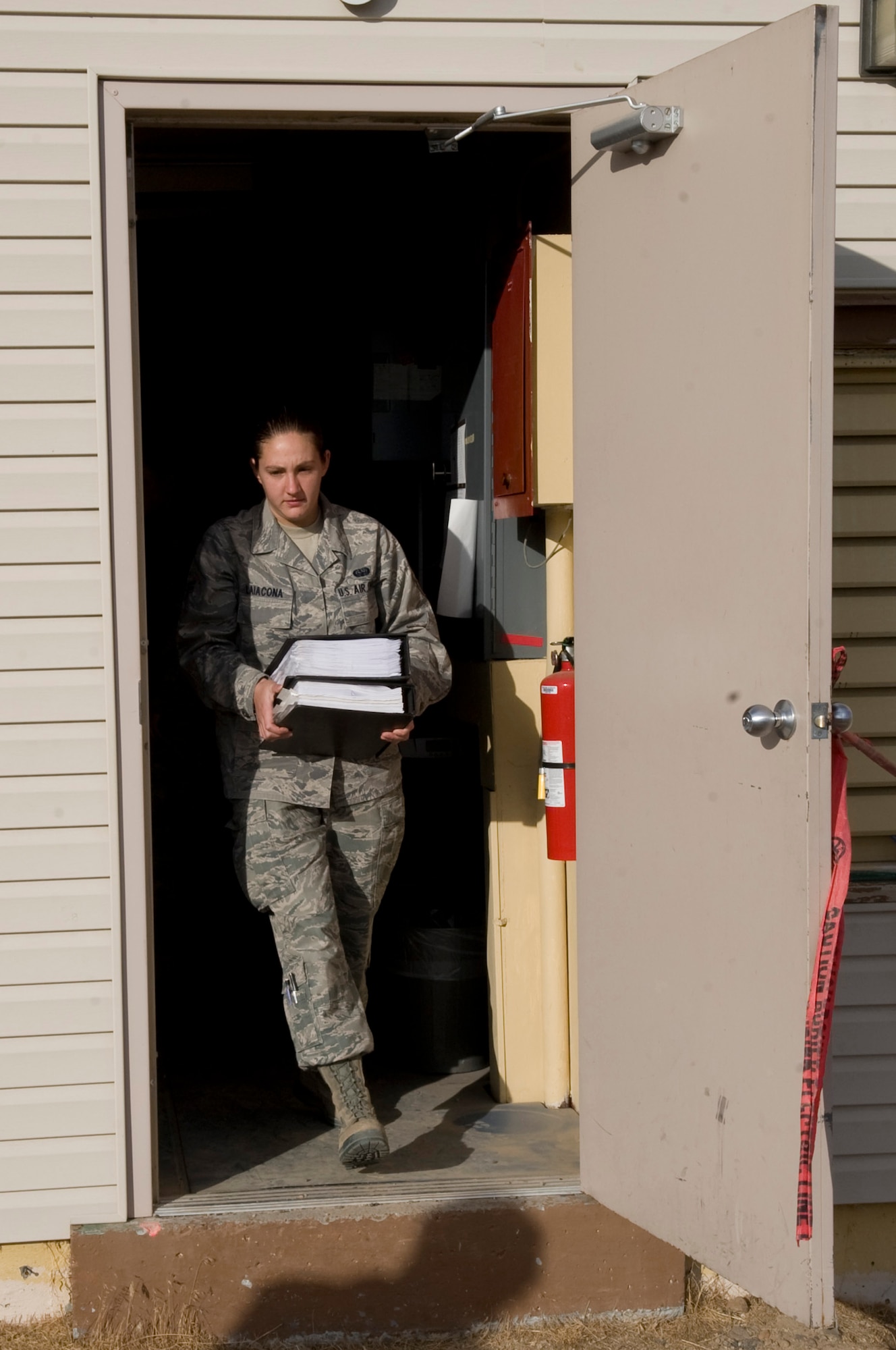 U.S. Air Force Airman 1st Class Amelia Laiacona, 366th Communication Squadron airfield systems apprentice, removes some of the few remaining items from the old Tactical Air Navigation System facility July 21, 2012, at Mountain Home Air Force Base, Idaho. The outdated structure will be demolished now that the TACAN system is up and running in an improved, temperature-controlled facility. (U.S. Air Force photo/Staff Sgt. Roy Lynch)