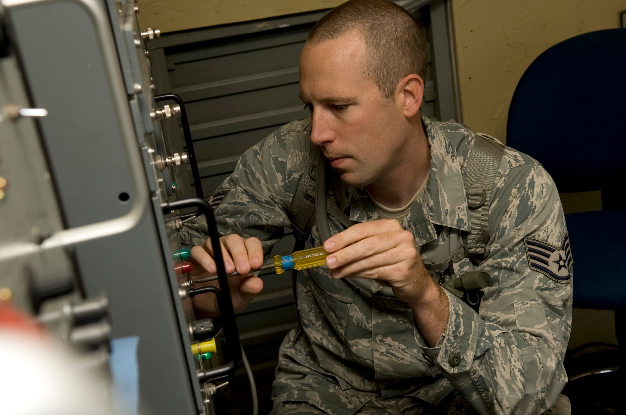 U.S. Air Force Staff Sgt. Mark De Jong, 366th Communication Squadron noncommissioned officer in charge airfield systems, removes panels from a Tactical Air Navigation System July 21, 2012, at Mountain Home Air Force Base, Idaho. The TACAN was moved into a new climate-controlled structure designed to improve the reliability and performance of the temperature-sensitive equipment. (U.S. Air Force photo/Staff Sgt. Roy Lynch)