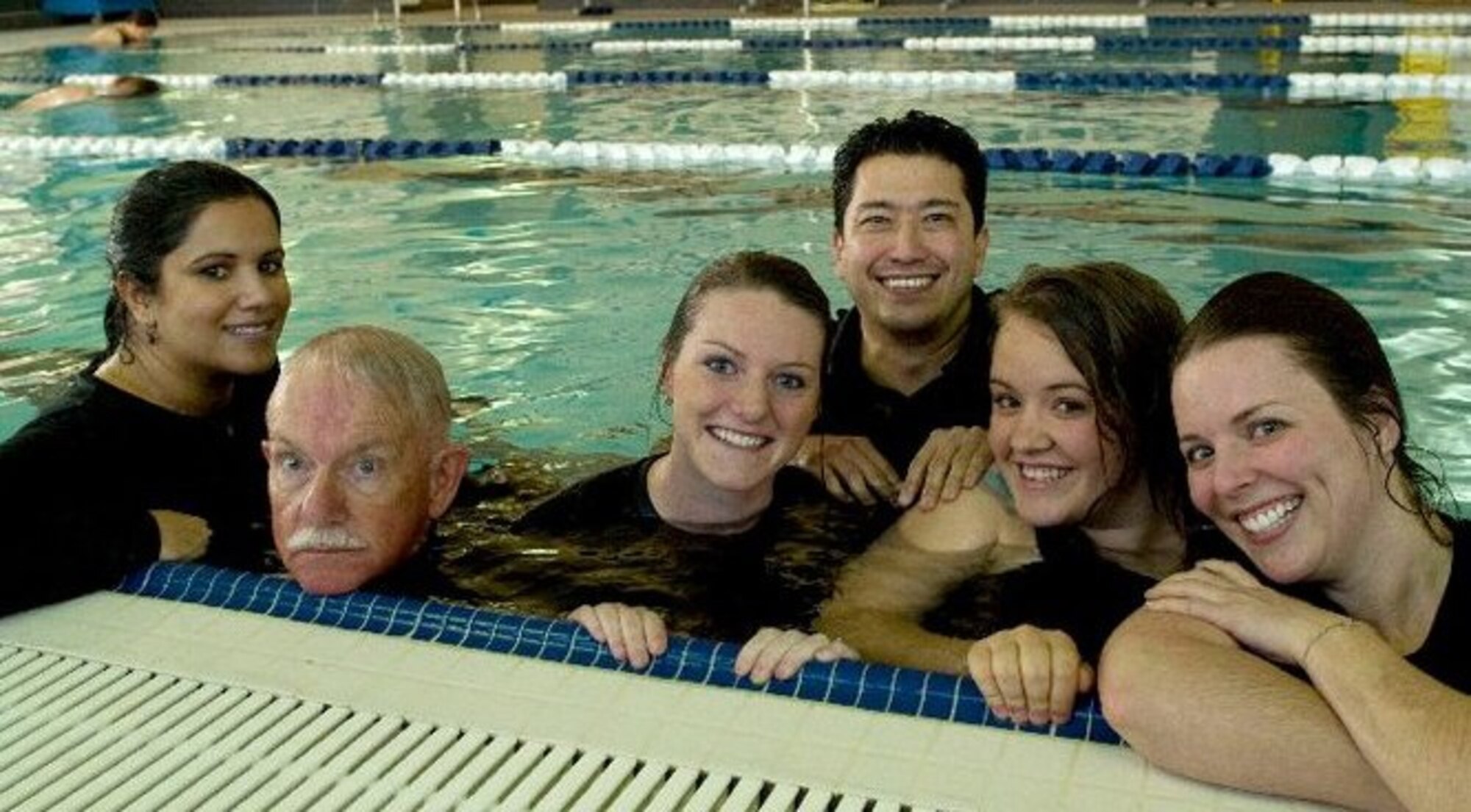 Dwight Harp, second from the left, 49th Force Support Squadron Marketing office commercial sponsorship coordinator, poses for a picture in the Holloman Air Force Base, N.M., Domenici Fitness Center pool, during a Marketing photo shoot in January 2011. Before coming to Holloman AFB one-and-a-half years ago, Harp was in radio broadcasting, radio advertising, and business assistance consulting. Harp, a New Mexico native, has lived in the Tularosa Basin for 23 years, and served in the U.S. Army for two years, where he was the officer in charge of the Defense Information School’s radio section. (Courtesy Photo)