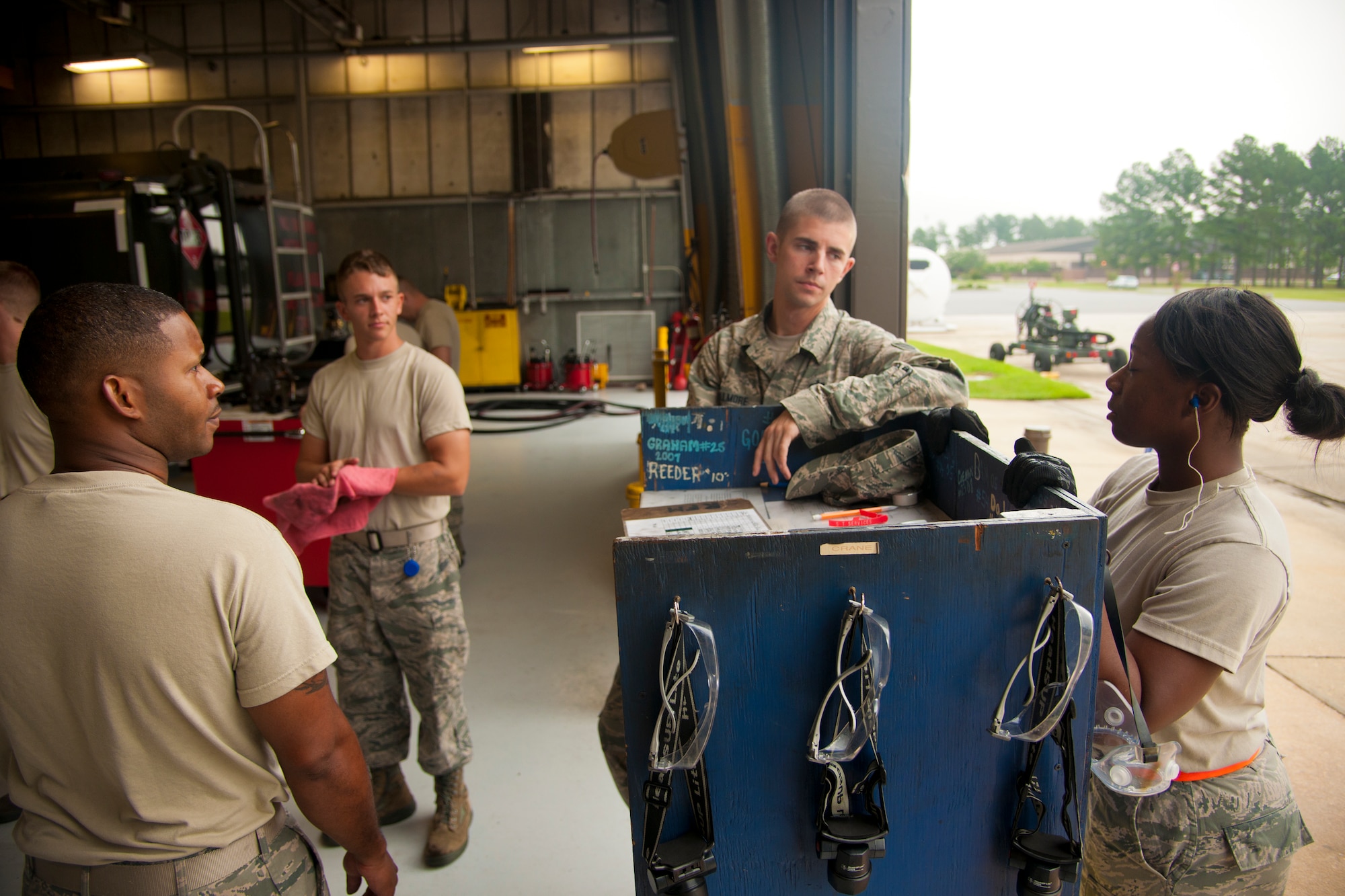 U.S. Air Force Airman from the 23d Logistics Readiness Squadron petroleum, oils and lubricants flight discuss the next steps to take after inspecting fuel trucks at Moody Air Force Base, Ga., Aug. 7, 2012. POL has a combined 6 main departments and has issued approximately 8.2 million gallons of JP-8 fuel in the past year. (U.S. Air Force photo by Airman 1st Class Paul Francis/Released)
