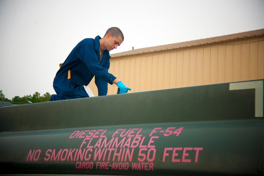 U.S. Air Force Airman 1st Class James Stossmeister, 23d Logistics Readiness Squadron fuels journeyman, checks for breaks or cracks in the seal of a man hole at Moody Air Force Base, Ga., Aug. 7, 2012. Stossmeister conducts multiple checks throughout the truck to verify everything is set before the truck is used. (U.S. Air Force photo by Airman 1st Class Paul Francis/Released)
