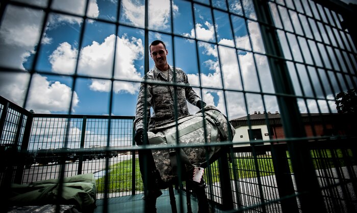 Staff Sgt. Trevor Miles, 437th Aerial Port Squadron facility manager, loads baggage into a new steel baggage bin Aug. 6, 2012 at Joint Base Charleston – Air Base, S.C. The team moves all baggage of deploying and returning military members here at Joint Base Charleston. (U.S. Air Force photo by Senior Airman Dennis Sloan)