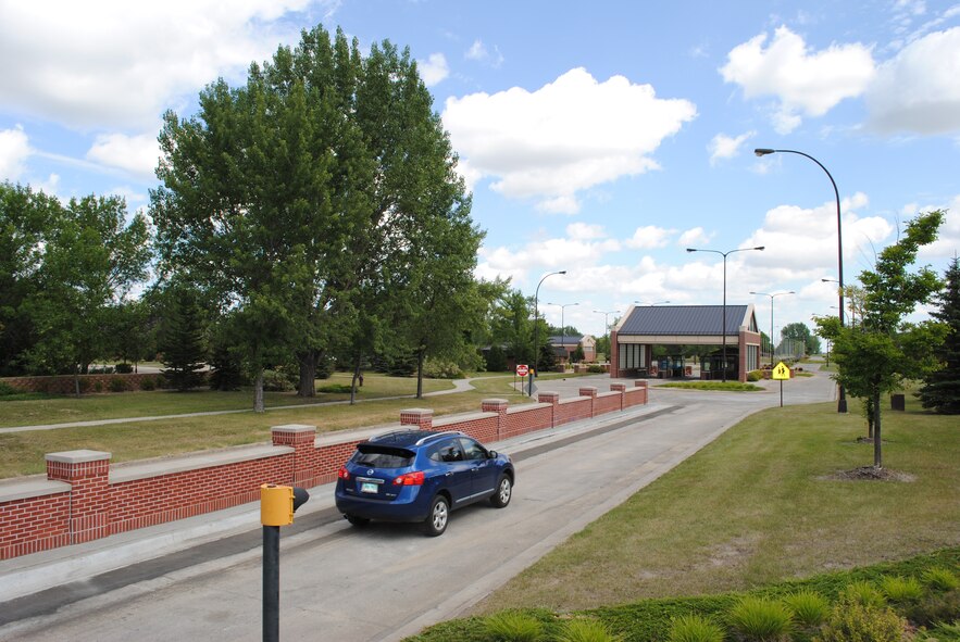A driver passes a new wall dividing traffic lanes at the main gate at Grand Forks Air Force Base, N.D., on Aug. 2, 2012. The gate reopened that day after a nearly two-month renovation project. (U.S. Air Force photo/Senior Airman Luis Loza Gutierrez)
