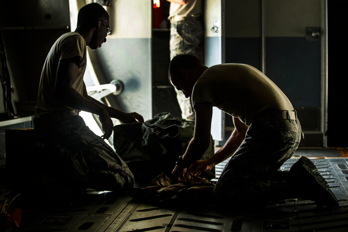 Senior Airman Dan Clarke and Staff Sgt. Philip DuChene, 437th Operations Support Squadron aircrew flight equipment technicians, pack equipment on a C-17 Globemaster III during a post-flight equipment swap-out Aug. 6, 2012, at Joint Base Charleston - Air Base, S.C. Members of AFE are essential to aircrews by making sure all flight equipment is in working order, including emergency safety equipment such as parachutes and survival equipment. (U.S. Air Force photo by Airman 1st Class George Goslin)