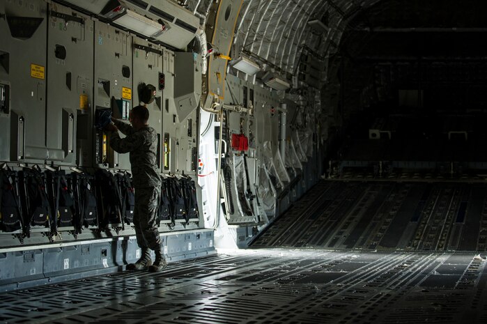 Staff Sgt. Philip DuChene, 437th Operations Support Squadron aircrew flight equipment technician, swaps out a Quick Don Mask on a C-17 Globemaster III during a post-flight equipment swap-out Aug. 6, 2012, at Joint Base Charleston - Air Base, S.C. Members of AFE are essential to aircrews by making sure all flight equipment is in working order including emergency safety equipment, such as parachutes and survival equipment. (U.S. Air Force photo by Airman 1st Class George Goslin)