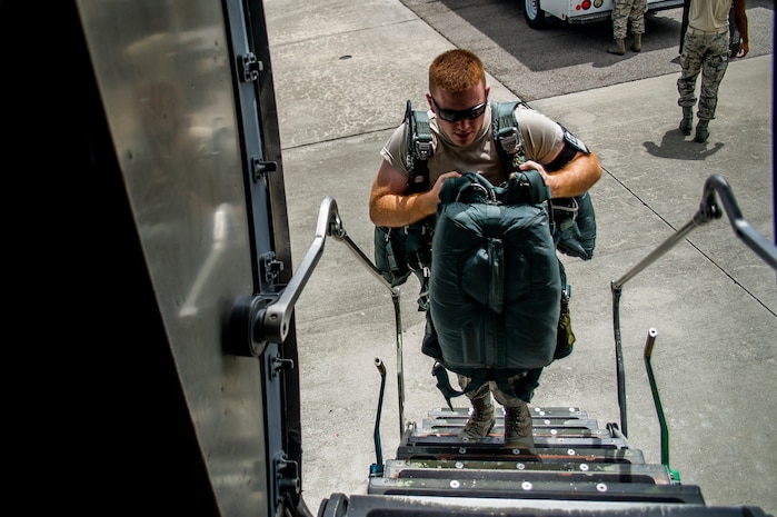 Airman 1st Class Jarod Young, 437th Operations Support Squadron aircrew flight equipment technician, carries parachutes onto a C-17 Globemaster III for an equipment swap-out Aug. 6, 2012, at Joint Base Charleston - Air Base, S.C. Members of AFE are essential to aircrews by making sure all flight equipment is in working order, including emergency safety equipment such as parachutes and survival equipment. (U.S. Air Force photo by Airman 1st Class George Goslin)