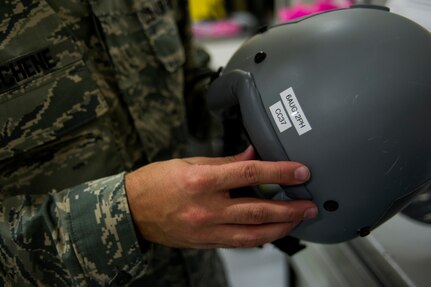 Staff Sgt. Philip DuChene, 437th Operations Support Squadron aircrew flight equipment technician, displays an expiration date for a helmet inspection Aug. 6, 2012, at Joint Base Charleston - Air Base, S.C. Members of AFE are essential to aircrews by making sure all flight equipment is in working order, including emergency safety equipment such as parachutes and survival equipment. (U.S. Air Force photo by Airman 1st Class George Goslin)