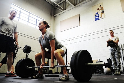 Tech Sgt. Amanda Helton, 1st Combat Camera Squadron broadcaster, performs a dead lift during a weightlifting test Aug. 3, 2012, at the fitness center at Joint Base Charleston - Air Base, S.C.  The weightlifting test included bench press, squats, dead lifts and pull-ups. The total amount each Airman lifted was divided by their body weight to give a pound-for-pound strength score in both the male and female categories.  The voluntary program was the first weight lifting test held by the 1st CTCS.  It was started by the unit’s fitness monitors to motivate Airmen to diversify their workouts and show them the importance of incorporating strength training.  (U.S. Air Force photo/ Staff Sgt. Nicole Mickle)