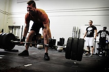 Chief Master Sgt. Robert Valenca, 1st Combat Camera Squadron superintendent, performs a dead lift during a weightlifting test Aug. 3, 2012, at the fitness center at Joint Base Charleston - Air Base, S.C.  The weightlifting test included bench press, squats, dead lifts and pull-ups. The total amount each Airman lifted was divided by their body weight to give a pound-for-pound strength score in both the male and female categories.  The voluntary program was the first weight lifting test held by the 1st CTCS.  It was started by the unit’s fitness monitors to motivate Airmen to diversify their workouts and show them the importance of incorporating strength training.  (U.S. Air Force photo/ Staff Sgt. Nicole Mickle) 
