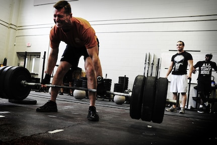 Chief Master Sgt. Robert Valenca, 1st Combat Camera Squadron superintendent, performs a dead lift during a weightlifting test Aug. 3, 2012, at the fitness center at Joint Base Charleston - Air Base, S.C.  The weightlifting test included bench press, squats, dead lifts and pull-ups. The total amount each Airman lifted was divided by their body weight to give a pound-for-pound strength score in both the male and female categories.  The voluntary program was the first weight lifting test held by the 1st CTCS.  It was started by the unit’s fitness monitors to motivate Airmen to diversify their workouts and show them the importance of incorporating strength training.  (U.S. Air Force photo/ Staff Sgt. Nicole Mickle) 