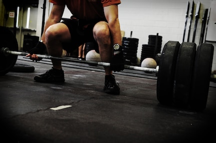 Chief Master Sgt. Robert Valenca, 1st Combat Camera Squadron superintendent, performs a dead lift during a weightlifting test Aug. 3, 2012, at the fitness center at Joint Base Charleston - Air Base, S.C.  The weightlifting test included bench press, squats, dead lifts and pull-ups. The total amount each Airman lifted was divided by their body weight to give a pound-for-pound strength score in both the male and female categories.  The voluntary program was the first weight lifting test held by the 1st CTCS.  It was started by the unit’s fitness monitors to motivate Airmen to diversify their workouts and show them the importance of incorporating strength training.  (U.S. Air Force photo/ Staff Sgt. Nicole Mickle)