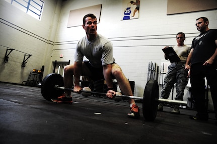 Staff Sgt. Robert Aten, 1st Combat Camera Squadron broadcaster, demonstrates a dead lift during a weightlifting test Aug. 3, 2012, at the fitness center at Joint Base Charleston - Air Base, S.C.  The weightlifting test included bench press, squats, dead lifts and pull-ups. The total amount each Airman lifted was divided by their body weight to give a pound-for-pound strength score in both the male and female categories.  The voluntary program was the first weight lifting test held by the 1st CTCS.  It was started by the unit’s fitness monitors to motivate Airmen to diversify their workouts and show them the importance of incorporating strength training.  (U.S. Air Force photo/ Staff Sgt. Nicole Mickle)