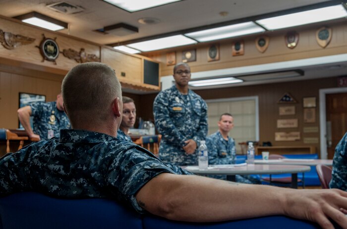 Aviation Ordnanceman Chief Petty Officer David Matlack, Naval Consolidated Brig Charleston, provides feedback to Interior Communications Electrician chief select Christopher Cawthon, NAVCONBRIG, during the Chief Petty Officer Indoctrination course Aug. 6, 2012, at Joint Base Charleston - Weapons Station, S.C. The CPOIC training is designed to prepare newly selected CPO's for their transition from petty officer 1st class to CPO. (U.S. Air Force photo/Airman 1st Class Ashlee Galloway)