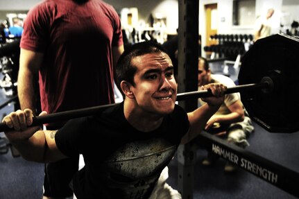 Airman 1st Class Nicholas Byers, 1st Combat Camera Squadron photographer, performs a squat during a weightlifting test Aug. 3, 2012, at the fitness center at Joint Base Charleston - Air Base, S.C.  The weightlifting test included bench press, squats, dead lifts and pull-ups. The total amount each Airman lifted was divided by their body weight to give a pound-for-pound strength score in both the male and female categories.  The voluntary program was the first weight lifting test held by the 1st CTCS.  It was started by the unit’s fitness monitors to motivate Airmen to diversify their workouts and show them the importance of incorporating strength training.  (U.S. Air Force photo/ Staff Sgt. Nicole Mickle)