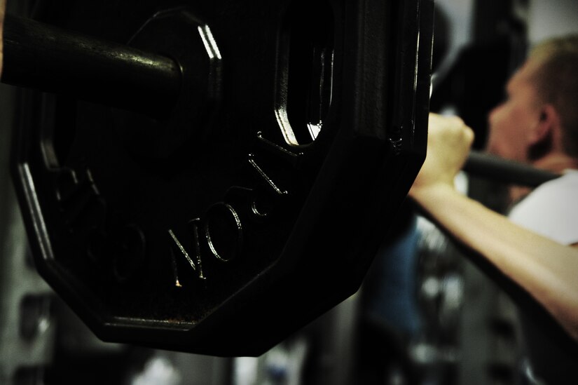 Airman Daniel Johnston, 1st Combat Camera broadcaster, performs a during a weightlifting test Aug. 3, 2012, at the fitness center at Joint Base Charleston - Air Base, S.C.  The weightlifting test included bench press, squats, dead lifts and pull-ups. The total amount each Airman lifted was divided by their body weight to give a pound-for-pound strength score in both the male and female categories.  The voluntary program was the first weight lifting test held by the 1st CTCS.  It was started by the unit’s fitness monitors to motivate Airmen to diversify their workouts and show them the importance of incorporating strength training.  (U.S. Air Force photo/ Staff Sgt. Nicole Mickle)