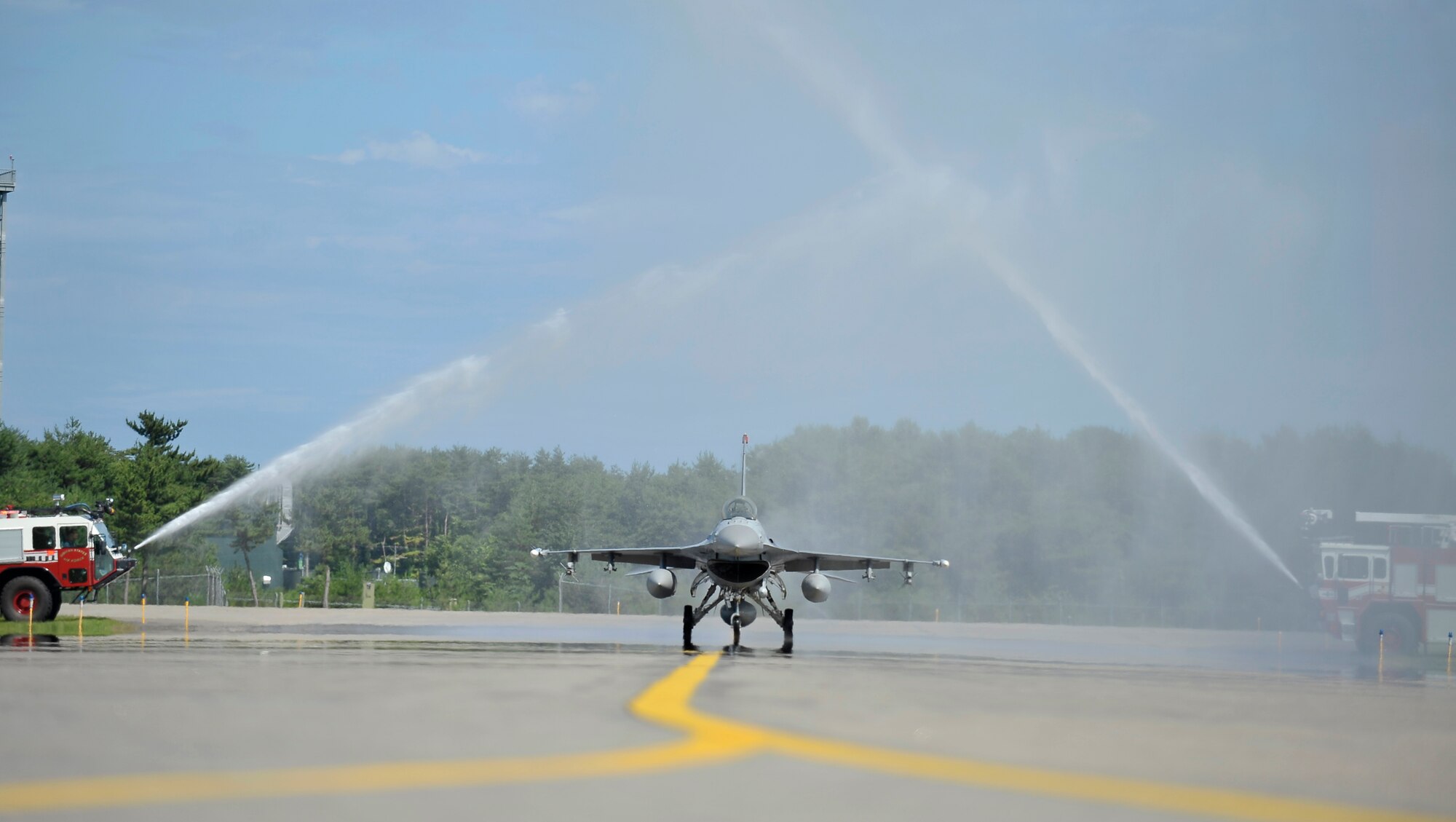 U.S. Air Force Col. Al Wimmer, 35th Fighter Wing vice commander, taxis under jets of water on the runway in an F-16 Fighting Falcon after his final flight at Misawa Air Base, Japan, Aug. 8, 2012. An experienced pilot with approximately 3000 flight hours, Wimmer is scheduled to serve at Tyndall Air Force Base, Fla. after completing his assignment with the Wild Weasels. (U.S. Air Force photo by Staff Sgt. Nathan Lipscomb/Released)