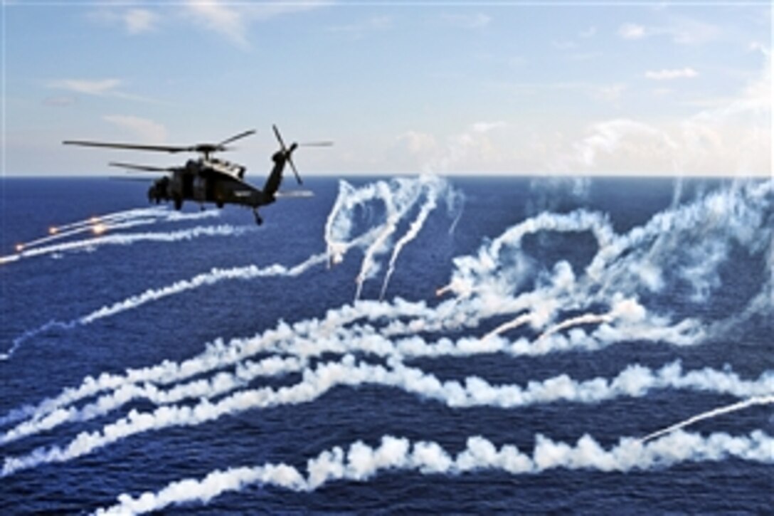 MH-60S Seahawk helicopters assigned to Helicopter Sea Combat Squadron 12 fire flares during a demonstration above the aircraft carrier USS Abraham Lincoln under way in the Atlantic Ocean, Aug. 6, 2012. The Lincoln is returning to the United States after completing an eight-month deployment during which it operated in areas of responsibility for the U.S. 5th, 6th and 7th fleets.