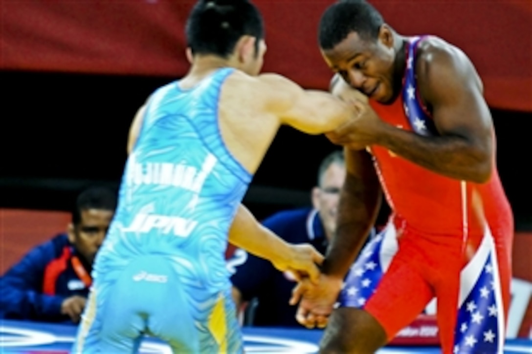 U.S. Army World Class Athlete Program wrestler Spc. Justin Lester, right, grapples with Japan's Tsutomu Fujimura in the first round of Olympic Greco-Roman wrestling in the 66-kilogram division during the Olympics in London, Aug. 7, 2012. Lester won that round, but lost to Hungary's Tomas Lorincz, who took the silver medal.