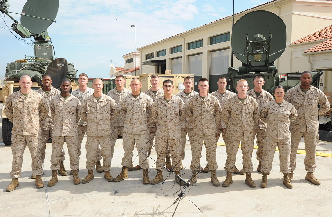 NAVAL AIR STATION SIGONELLA, Italy - Marines assigned to the Joint Task Force Enabler detachment, 24th Marine Expeditionary Unit, pose for a group photo in front of their equipment at Naval Air Station Sigonella where they are currently deployed supporting commercial and military internet and telephone services for 24th MEU Marines conducting exercises ashore throughout the European and Central Command theaters of operation.  From their location in Italy, the JTFE provides communications services to the other elements of the MEU using satellite terminals and connections that reach across the world to locations as far away as Jordan, Kuwait, and Djibouti.  (Photo courtesy of the Joint Task Force Enabler detachment, 24th Marine Expeditionary Unit)