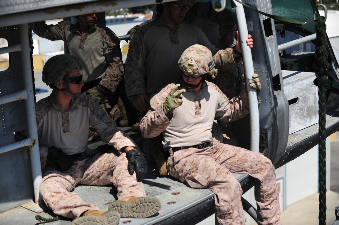 SAN DIEGO -- Marines with the 11th Marine Expeditionary Unit's maritime raid force use hand signals to communicate with each other before fast roping out of a static aircraft at the Strategic Operations Facility here Aug. 6. The raid force consists of a reconnaissance element, an infantry element, an Intelligence element, explosive ordinance disposal Marines and a 1st Air Naval Gunfire company detachment.