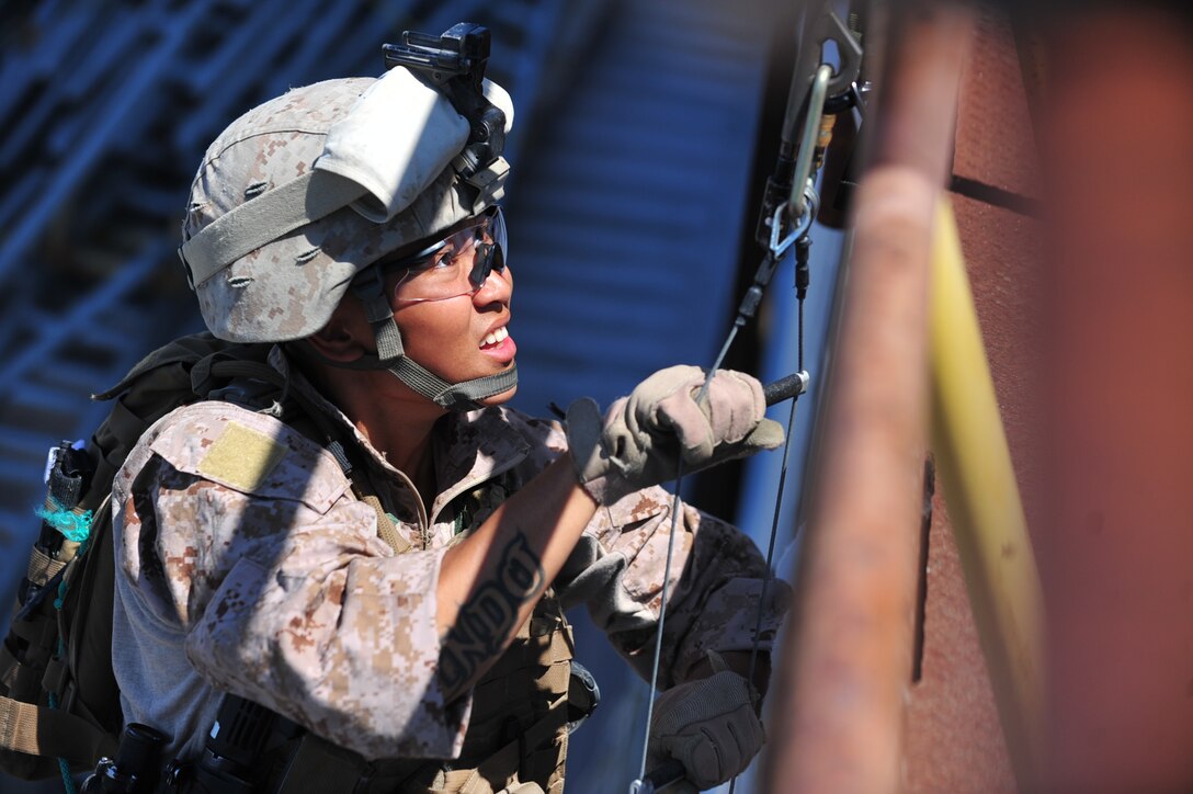 SAN DIEGO -- Cpl. Jethro Sofyan, an infantryman and team leader with the 11th Marine Expeditionary Unit's maritime raid force, climbs aboard a simulated ship during training at the Strategic Operations Facility here Aug. 6. The raid force consists of a reconnaissance element, an infantry element, an Intelligence element, explosive ordnance disposal Marines and a 1st Air Naval Gunfire company detachment.