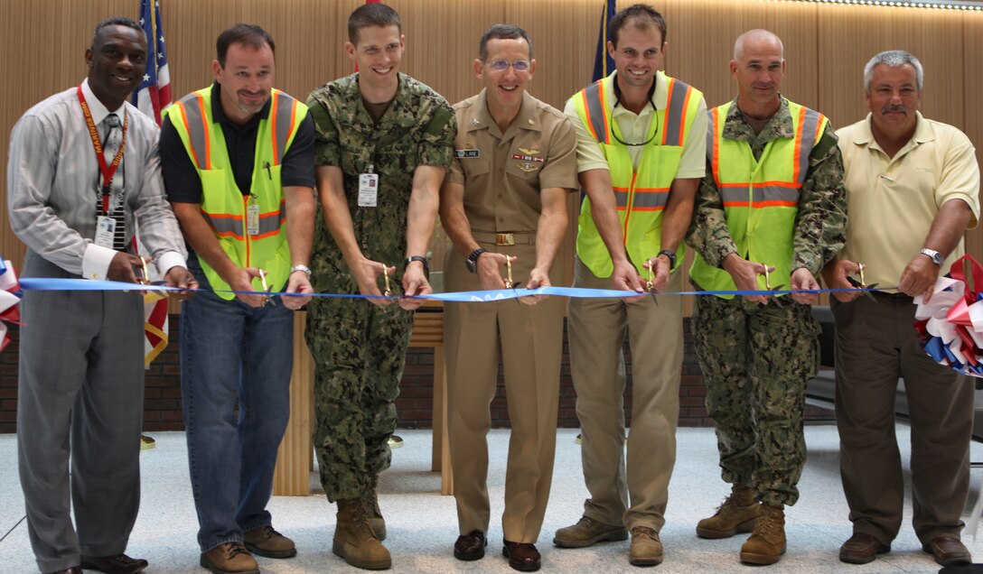 Capt. David Lane, the commanding officer of the hospital, along with hospital personnel and construction workers responsible for construction cut the ribbon marking the opening of Naval Hospital Camp Lejeune’s new quarterdeck and lobby aboard Marine Corps Base Camp Lejeune, Aug. 8. The opening is the first aspect of NHCL’s renovations efforts noticeable to visitors.   