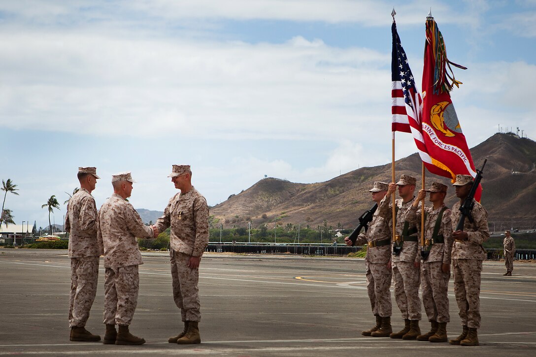 MARINE CORPS BASE HAWAII – Gen. James F. Amos, commandant of the Marine Corps, shakes hands and congratulates Lt. Gen. Duane D. Thiessen on being awarded the Distinguished Service Medal for his accomplishments as the commander of U.S. Marine Corps Forces, Pacific after a change-of-command ceremony aboard Marine Corps Air Station, Kaneohe Bay, here, Aug. 2. Thiessen relinquished command to Lt. Gen. Terry G. Robling, and then retired to conclude his 38-year career.
