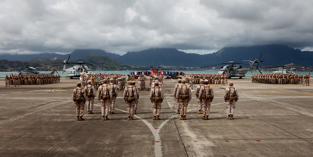 MARINE CORPS BASE HAWAII – The crowd and parade formation watch as the U.S. Marine Corps Forces, Pacific Band performs during the MarForPac change-of-command ceremony in which Lt. Gen. Duane D. Thiessen relinquished command to Lt. Gen. Terry G. Robling at Marine Corps Air Station, Kaneohe Bay, here, Aug. 2. Thiessen retired afterward, marking the end of a 38-year career.